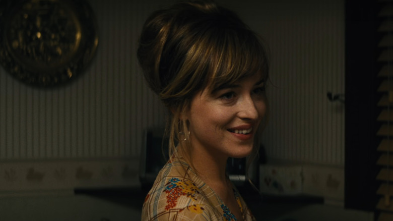 Lindsey (Dakota Johnson) smiling in kitchen in Black Mass