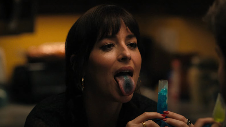 Domino (Dakota Johnson) shows off her blue tongue while eating an ice pop in Cha Cha Real Smooth