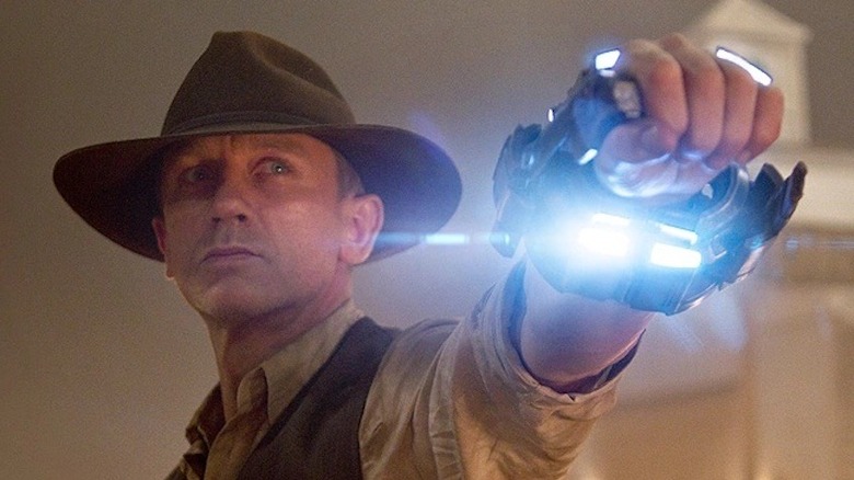 Daniel Craig in Cowboys & Aliens holding wrist light