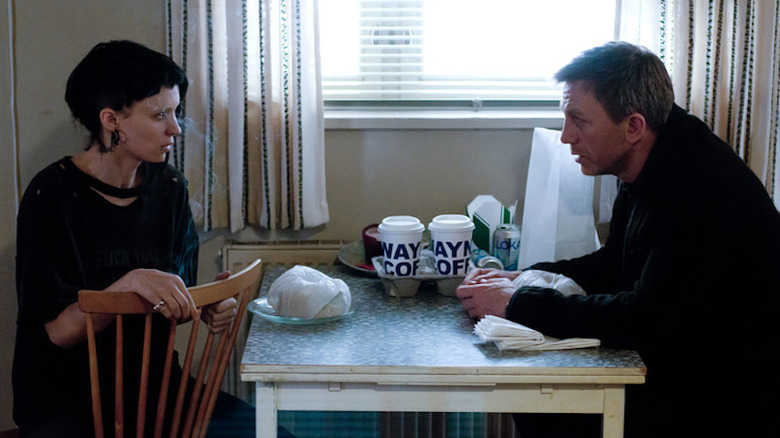 Daniel Craig in the Girl with the Dragon Tattoo drinking coffee with Rooney Mara
