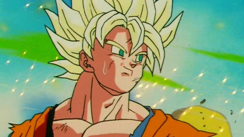 Super Saiyan Goku smiles knowingly through glittering debris in Dragon Ball Z
