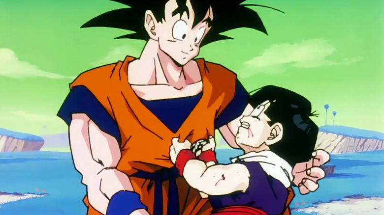 Goku cradles an injured Gohan in Dragon Ball Z