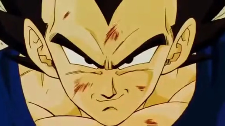 A bruised Vegeta smirks smugly in Dragon Ball Z