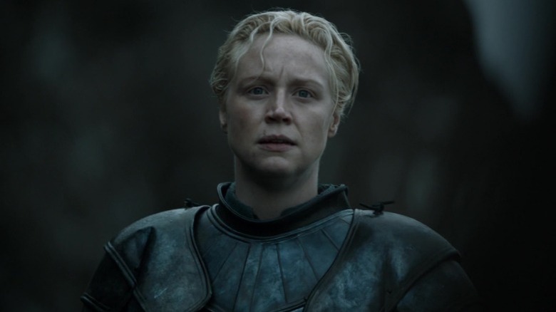Gwendoline Christie as Brienne of Tarth standing with a grave expression on Game of Thrones