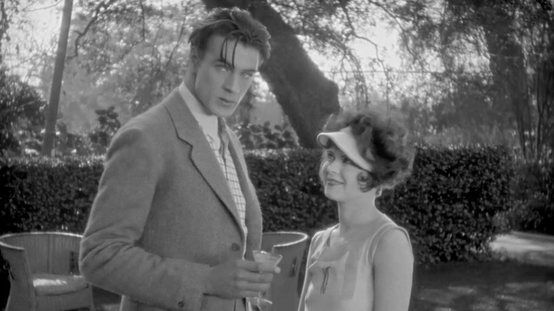Ted (Gary Cooper) staring at Jean while Kitty (Clara Bow) stares at Ted in Children of Divorce
