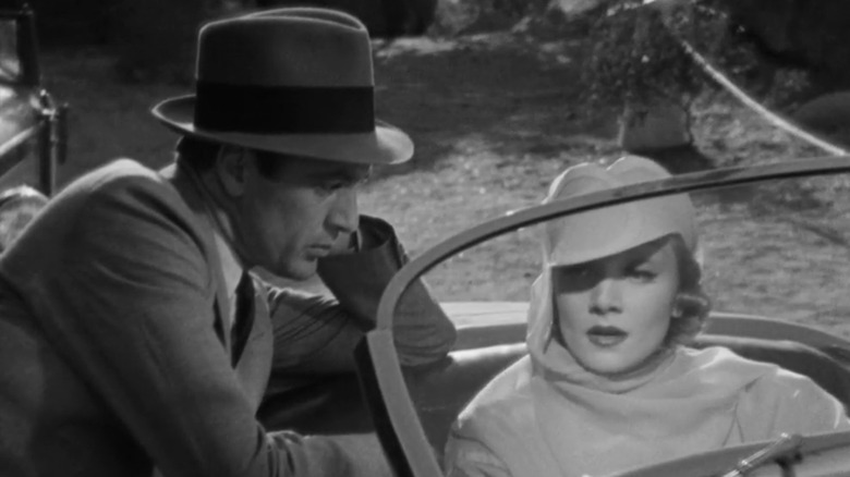 Tom (Gary Cooper) leaning into Madeleine's (Marlene Dietrich) car in Desire
