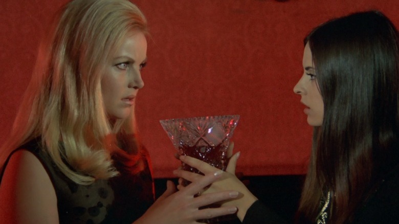 Nadine hands Linda a carafe of blood