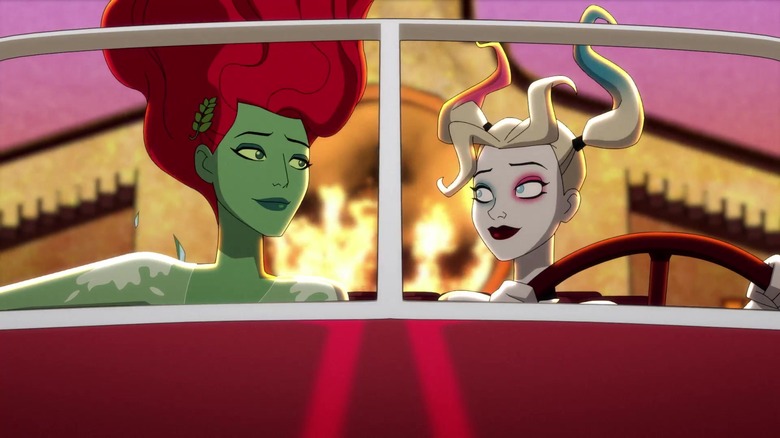Harley Quinn's Ivy and Harley riding in flying car with fire behind them