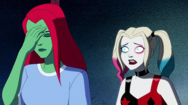 Harley Quinn's Ivy with hand on face in blue hospital gown next to Harley