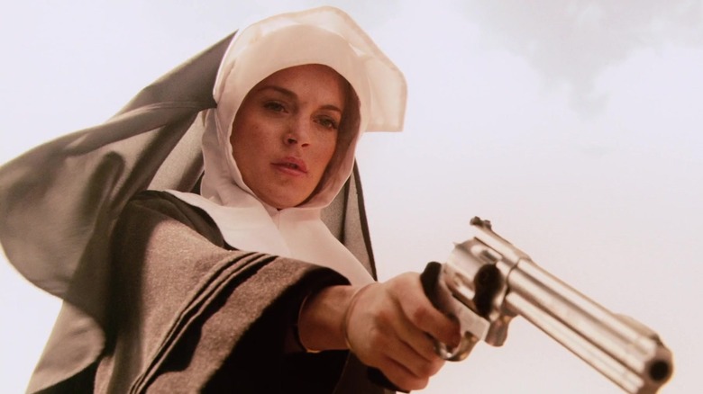 Lindsay Lohan pointing revolver in nun's habit as April in Machete