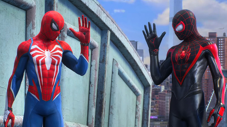Peter Parker (Yuri Lowenthal) and Miles Morales (Nadji Jeter) greet each other in-costume in Marvel's Spider-Man 2