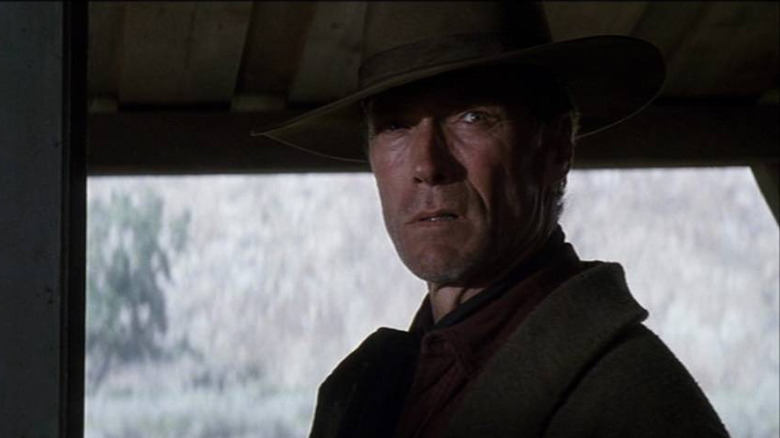 William Munny (Clint Eastwood) standing in doorway in Unforgiven