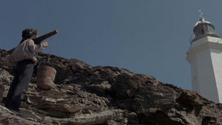 Will Denton (Kirk Douglas) looks at a lighthouse in The Light at the Edge of the World
