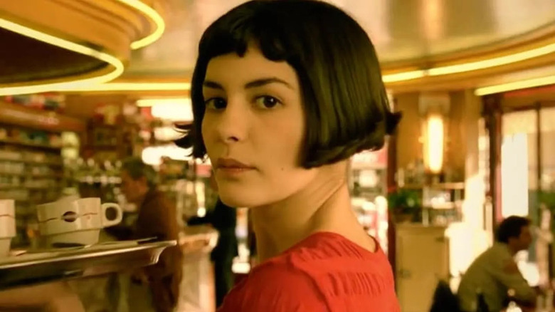 Amélie Poulain (Audrey Tautou) carries a tray in a cafe in Amélie