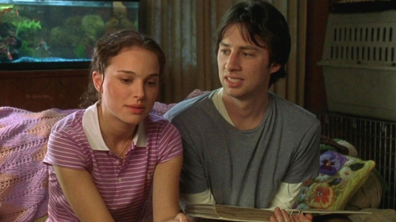 Sam (Natalie Portman) looks annoyed next to Andrew (Zach Braff) with a photo album open in Garden State