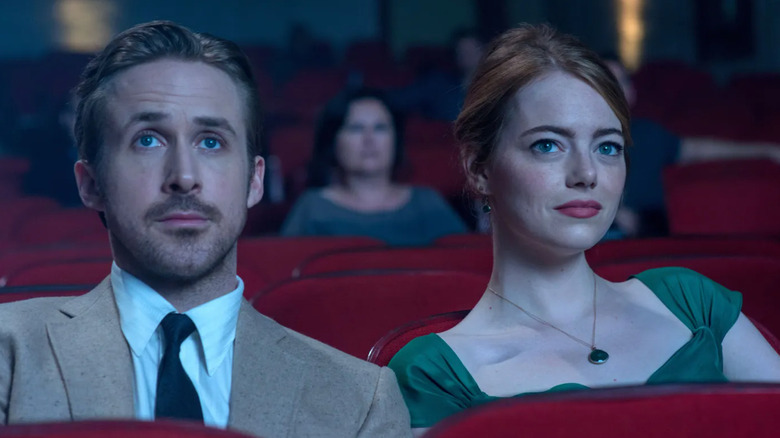 Seb Wilder (Ryan Gosling) and Mia Dolan (Emma Stone) sit next to each other in a movie theater in La La Land