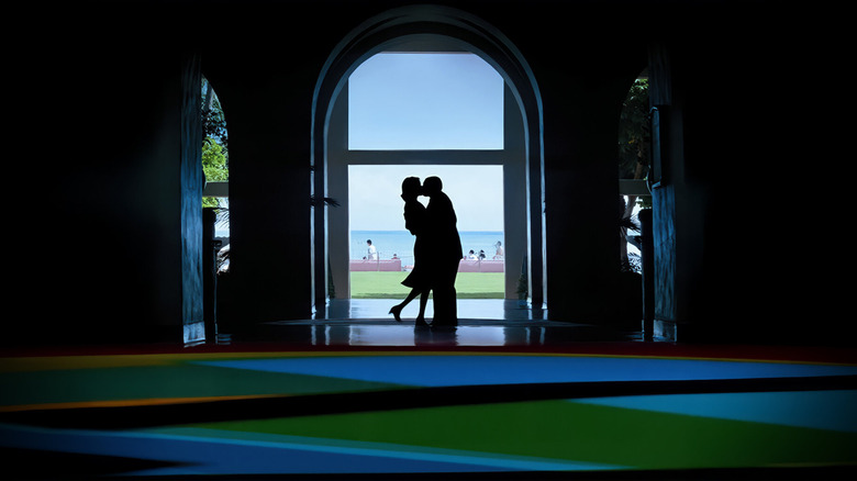 Barry Egan (Adam Sandler) kisses Lena Leonard (Emily Watson) while framed in a doorway in Punch-Drunk Love