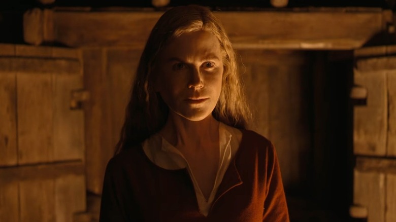 Nicole Kidman as Gudrun looking determined in the glow of a fire in The Northman