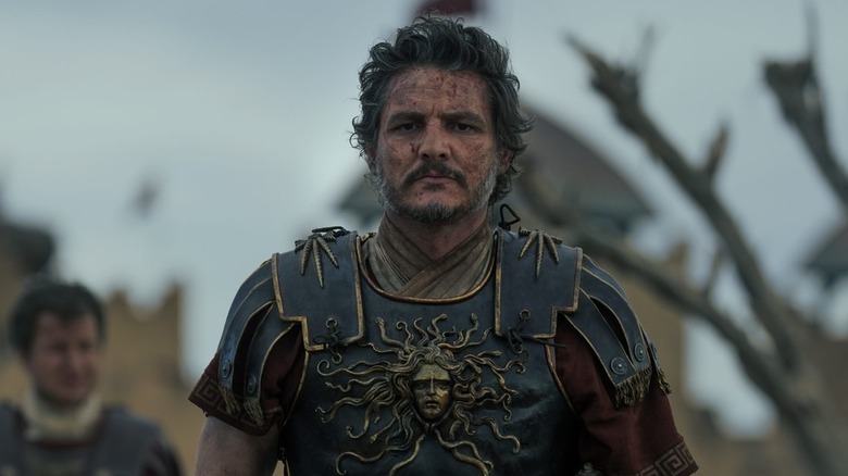 A bloodied Marcus Acacius (Pedro Pascal) walks on the battlefield in Gladiator II