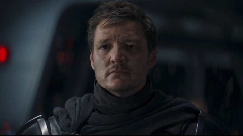 Din Djarin (Pedro Pascal) stands without a helmet with tears in his eyes in The Mandalorian