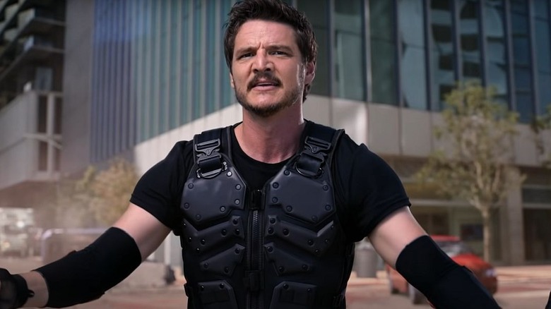 Marcus Moreno (Pedro Pascal) wields two batons in the street in We Can Be Heroes