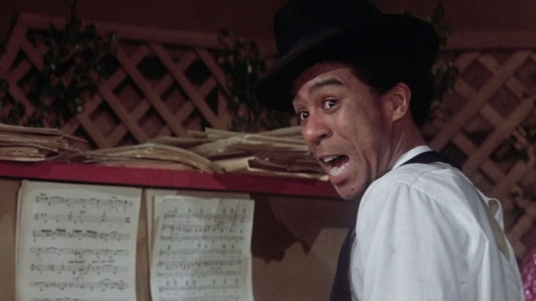 Piano Man (Richard Pryor) plays the piano while looking back in Lady Sings the Blues