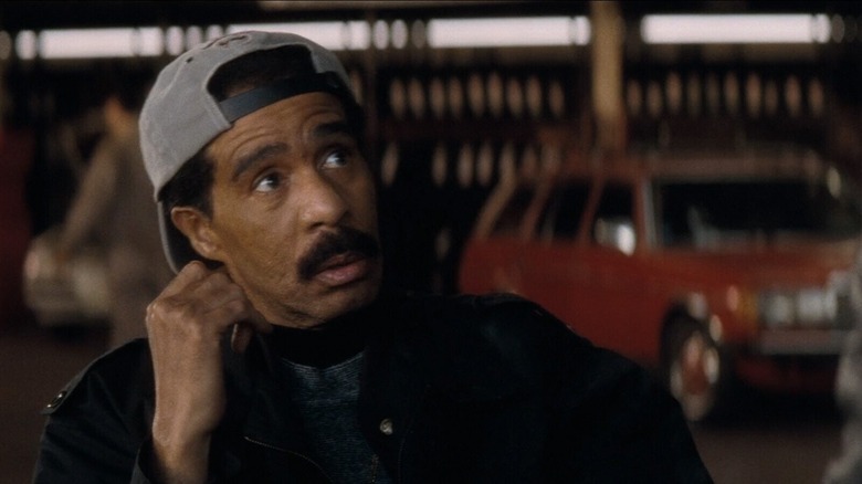Arnie (Richard Pryor) looks up in his garage in Lost Highway