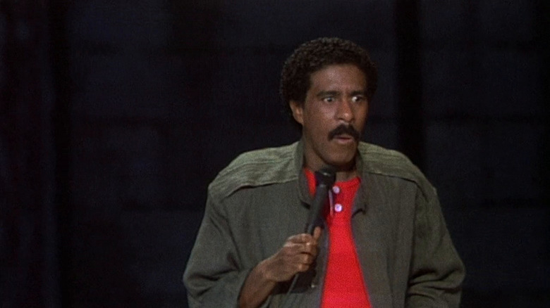 Richard Pryor makes a face while holding a mic on stage in Richard Pryor: Here and Now
