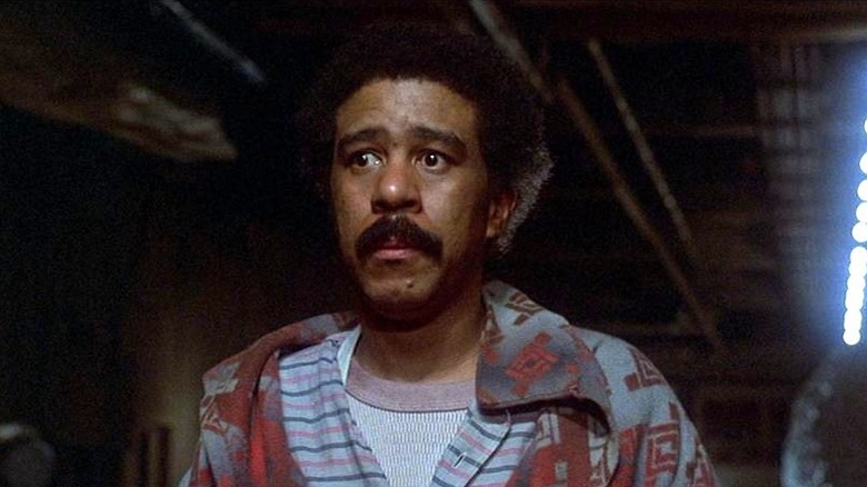 Herman Smith (Richard Pryor) stands in a dark hallway in The Wiz