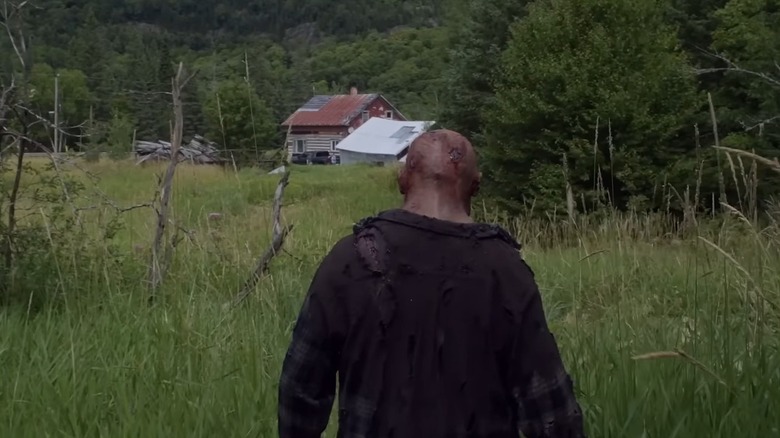 The back of Johnny's bloody head as he walks toward a house, from In a Violent Nature