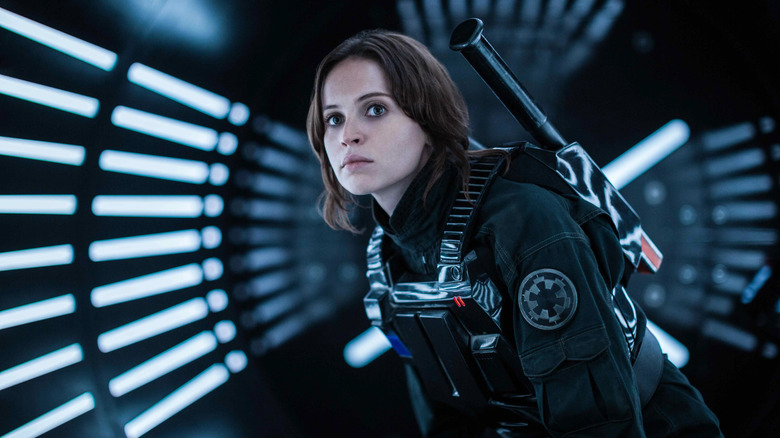 Jyn Erso (Felicity Jones) stands in an Imperial uniform in a light hallway in Rogue One: A Star Wars Story