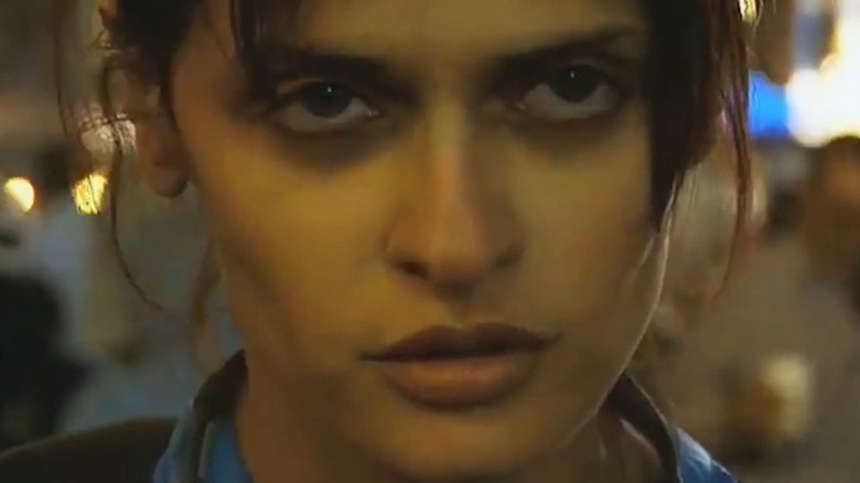 Luisa Williams as She with a severe expression on her face in Day Night Day Night