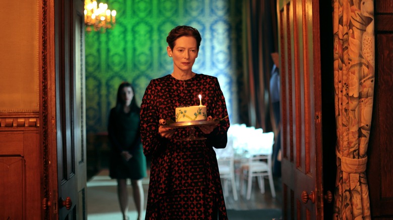 The Eternal Daughter's Tilda Swinton holding birthday cake