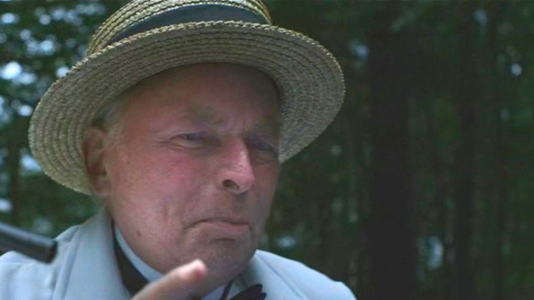 Mog traces the path of a bullet with his finger, scowling, in Koko-di, Koko-da