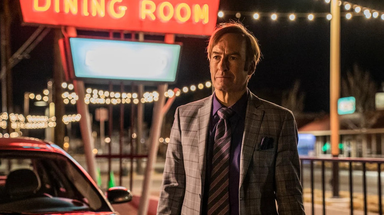 Saul Goodman (Bob Odenkirk) stands in a lit-up parking lot on Better Call Saul