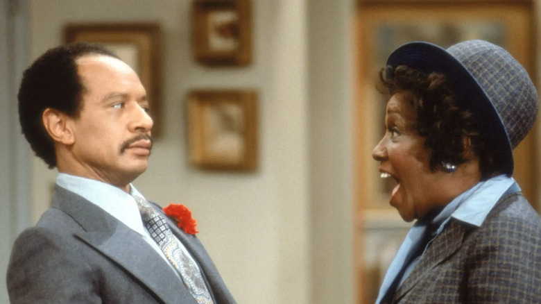 George Jefferson (Sherman Hemsley) recoils as Louise (Isabel Sanford) expresses surprise on The Jeffersons