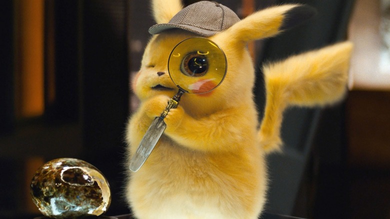 Pikachu holds magnifying glass to eye in Detective PIkachu (2019)