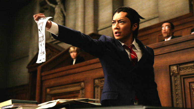 Phoenix Wright holding out papers in court in Ace Attorney (2012)
