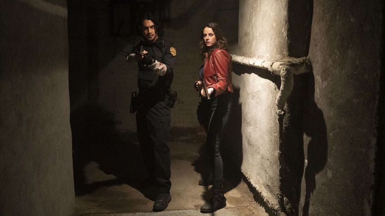 Leon Kennedy and Claire Redfield in a basement hallway in Resident Evil: Welcome to Raccoon City (2021)