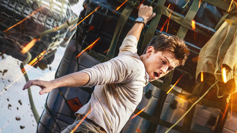 Nathan Drake hanging off of plane cargo