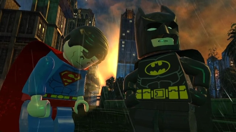 Superman looking down while Batman poses in Lego Batman: DC Super Heroes