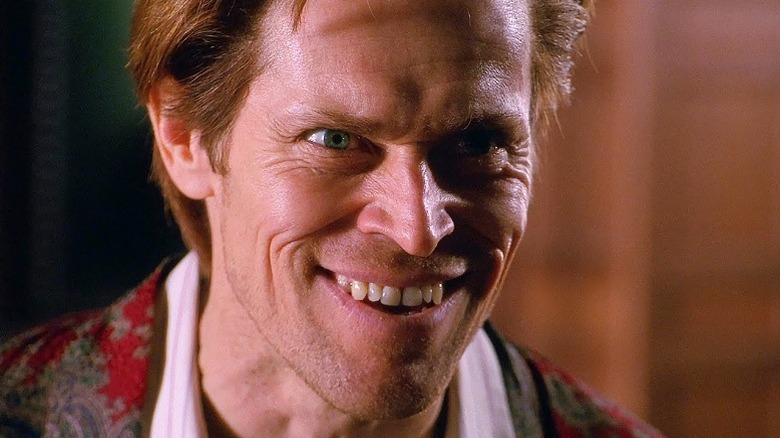 Willem Dafoe smiling maniacally
