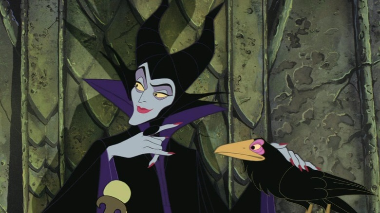 Maleficent pets her crow friend.