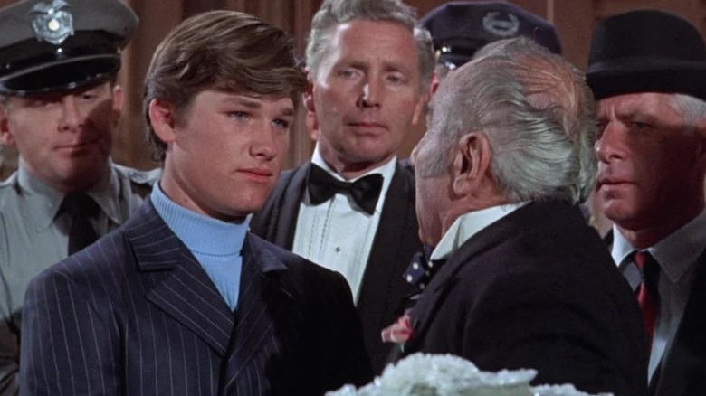 Improbably young Kurt Russell brings the cops.