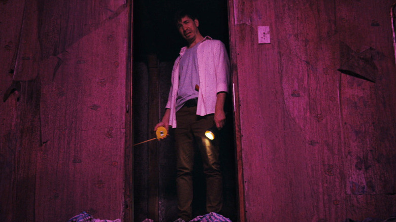 Justin Long holding flashlight in Barbarian