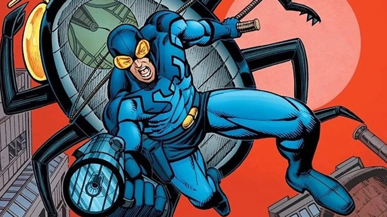 Blue Beetle descends from his hovering Beetle ship with a ray gun on the cover of Blue Beetle (vol. 2) #1