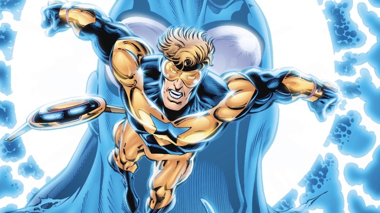 Booster Gold and Skeets fly in front of a Blue Beetle cowl on the cover of Booster Gold (vol. 2) #0