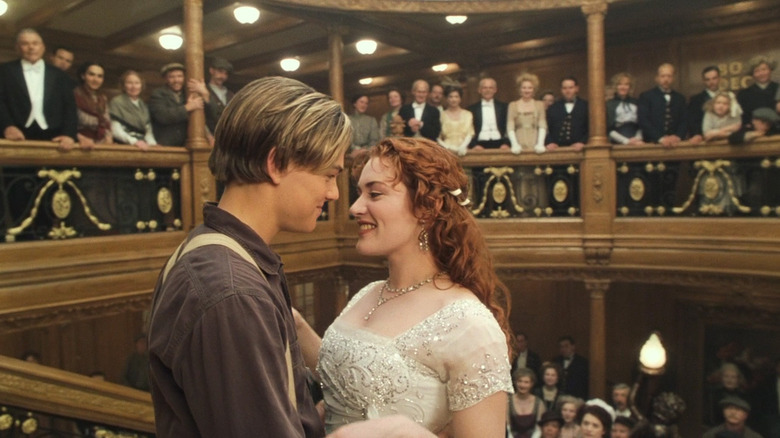 Titanic's Jack and Rose leaning towards each other on stairway of ship