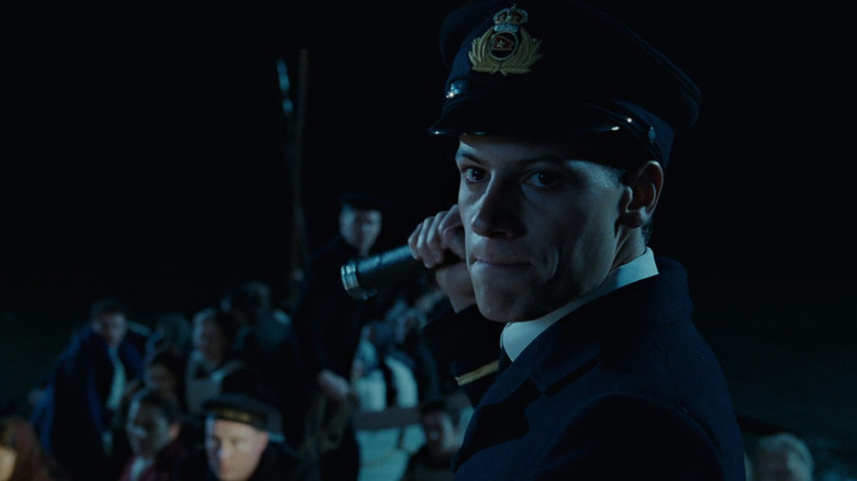Titanic officer shining flashlight on lifeboat