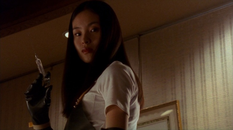 Eihi Shiina as Asami in Audition, holding a syringe